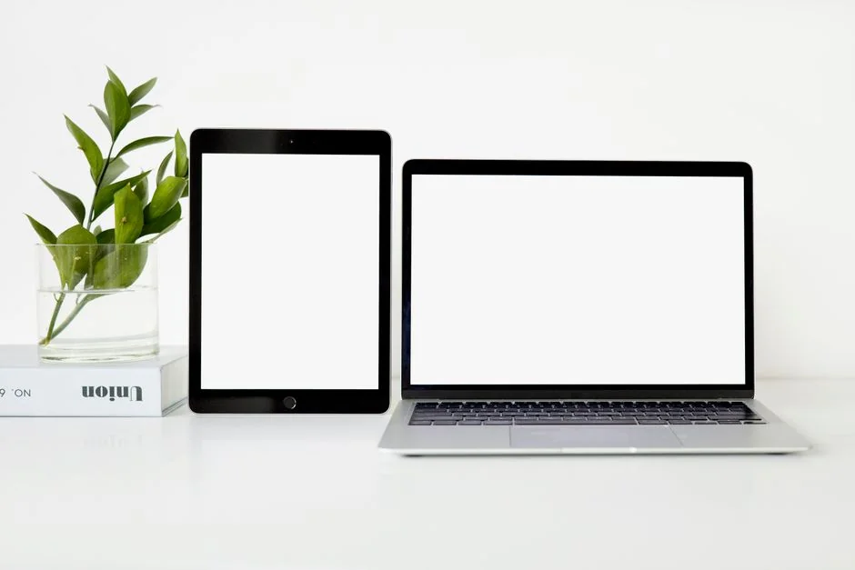 A modern workspace featuring dual computer monitors displaying web design projects, emphasizing technology and productivity.